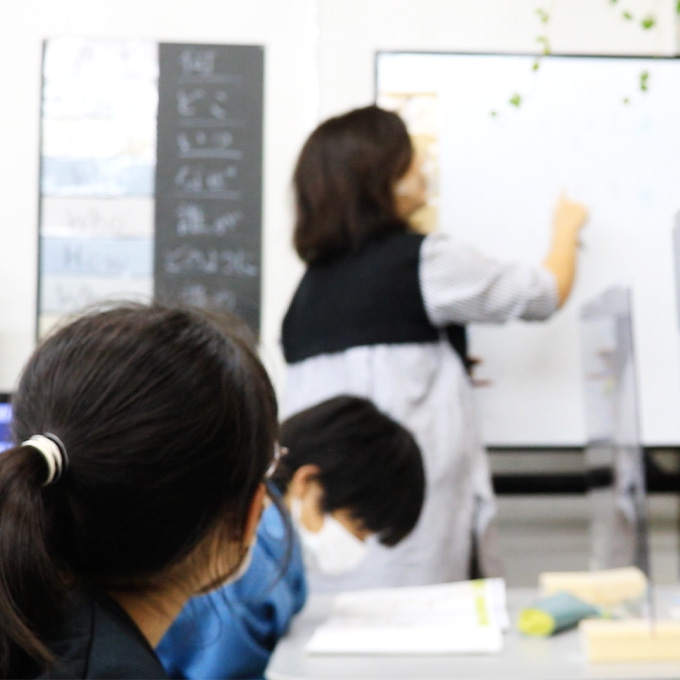 ホワイトボードで英語を学ぶ子供